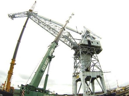 Wharf crane being removed by mobile crane