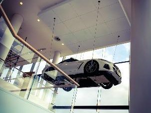 Car suspended in a glass showroom atrium