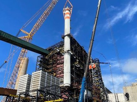 Boiler structure under construction with crawler crane
